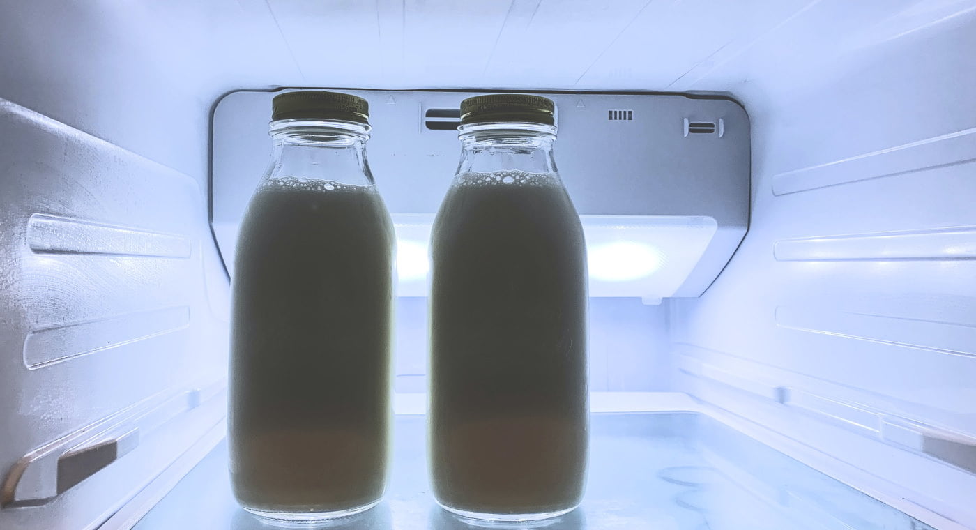 Milk bottles standing in fridge