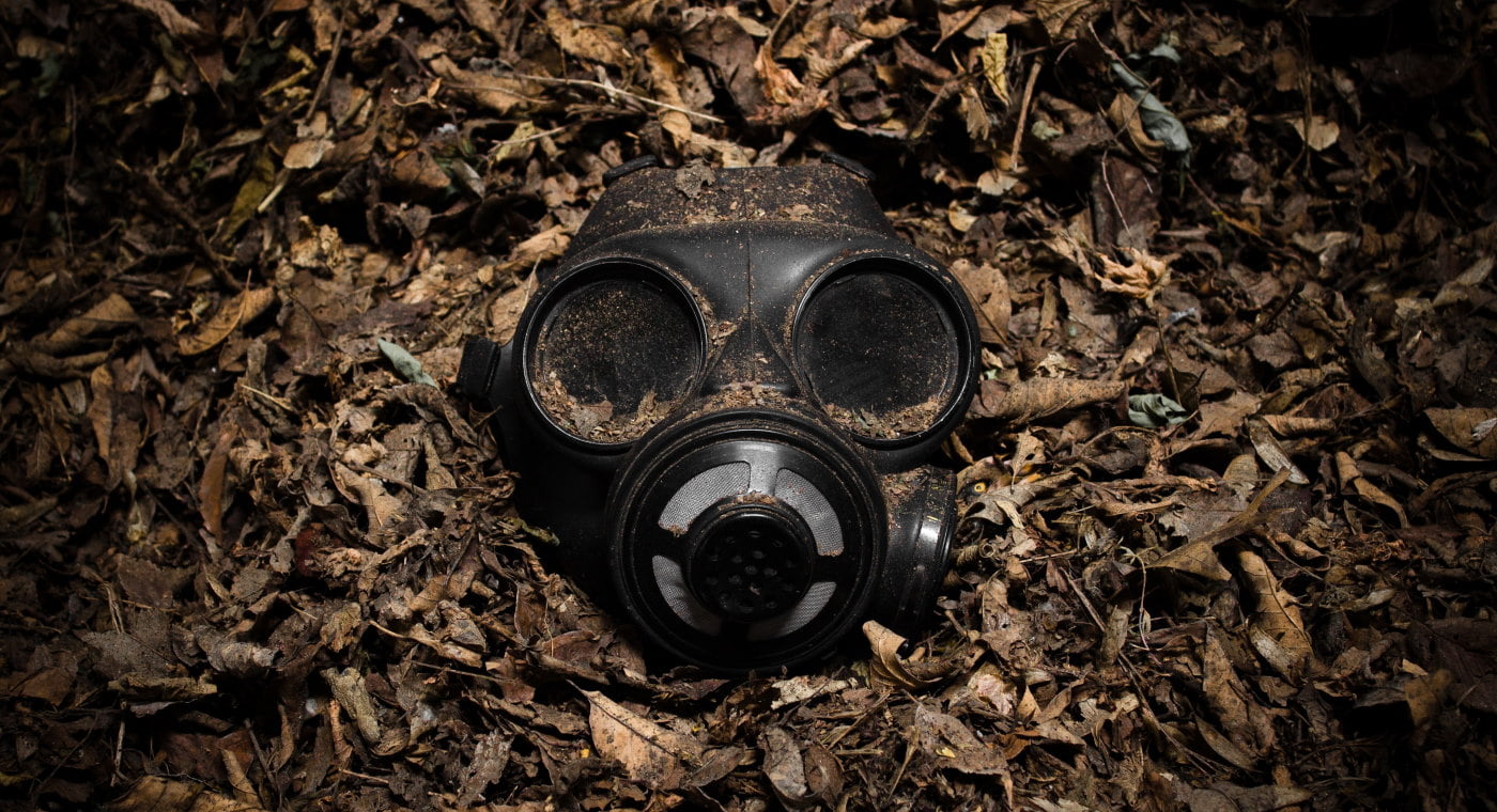 Gas mask buried in loose soil